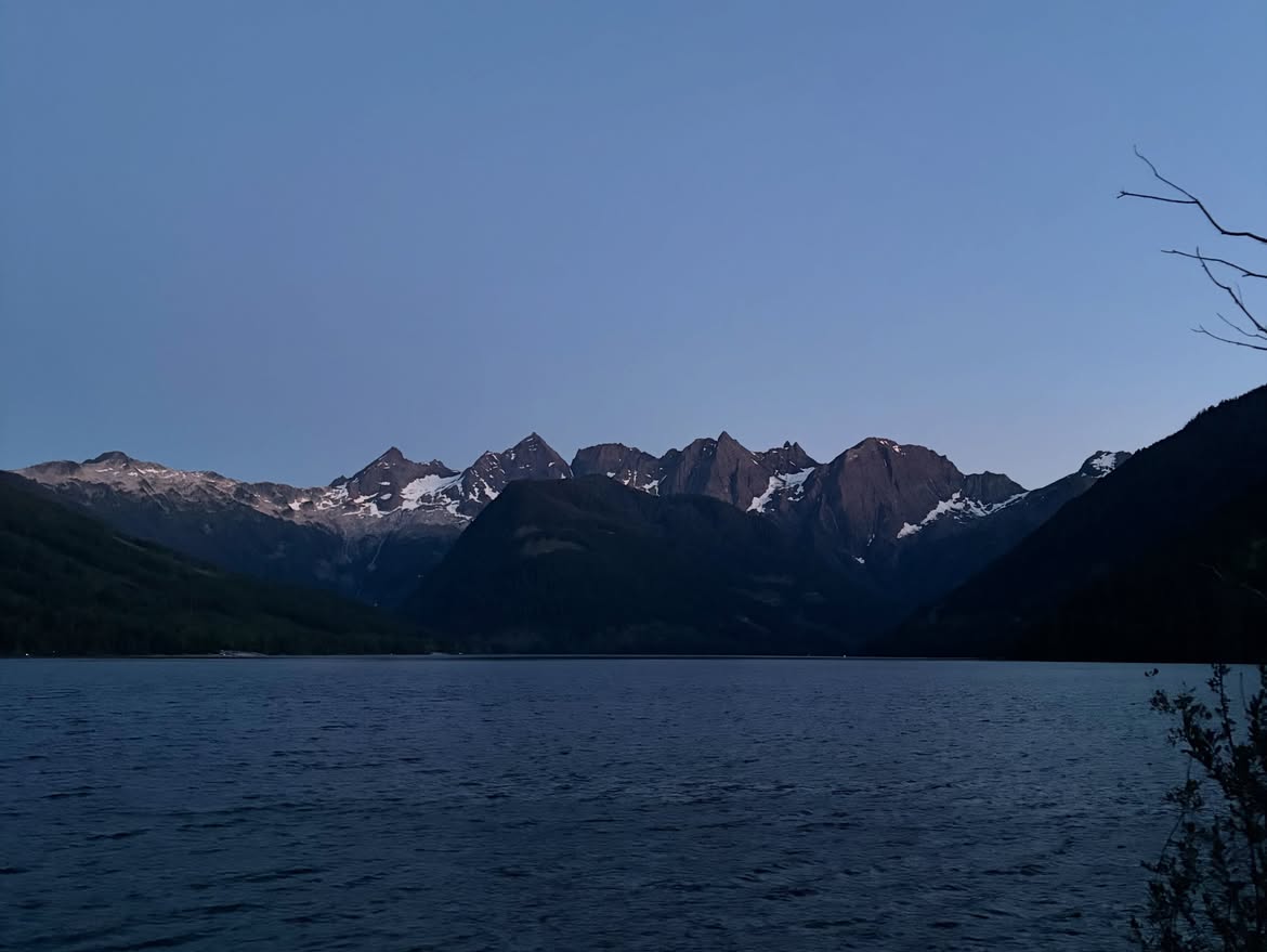 Johnson Lake at dusk with mountain silhouettes along the horizon