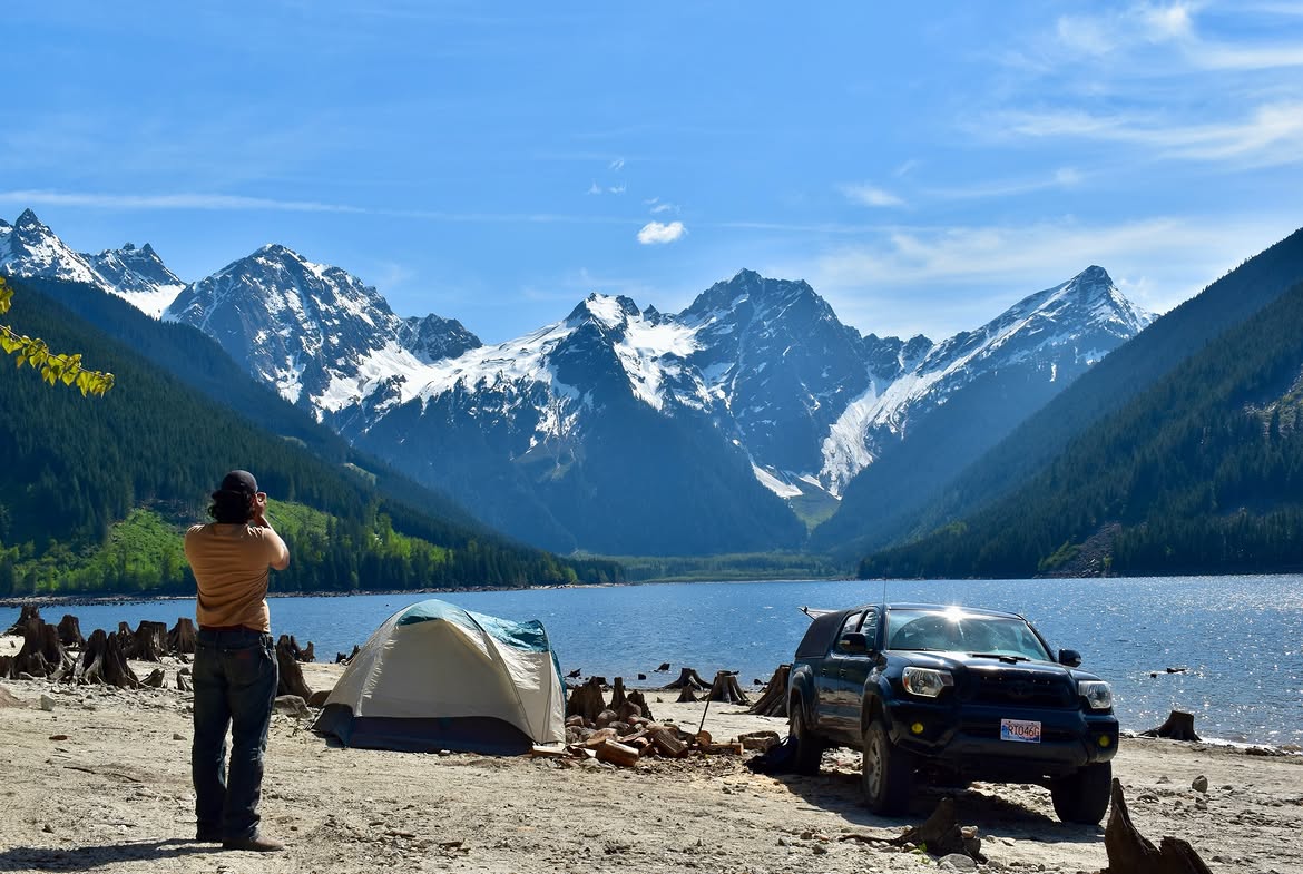 Calm reflective water at Johnson Lake with the Rocky Mountains in the background