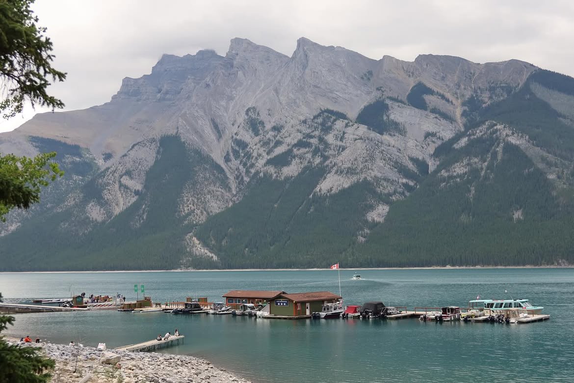 Lake Minnewanka marina and mountain backdrop under an overcast Banff sky