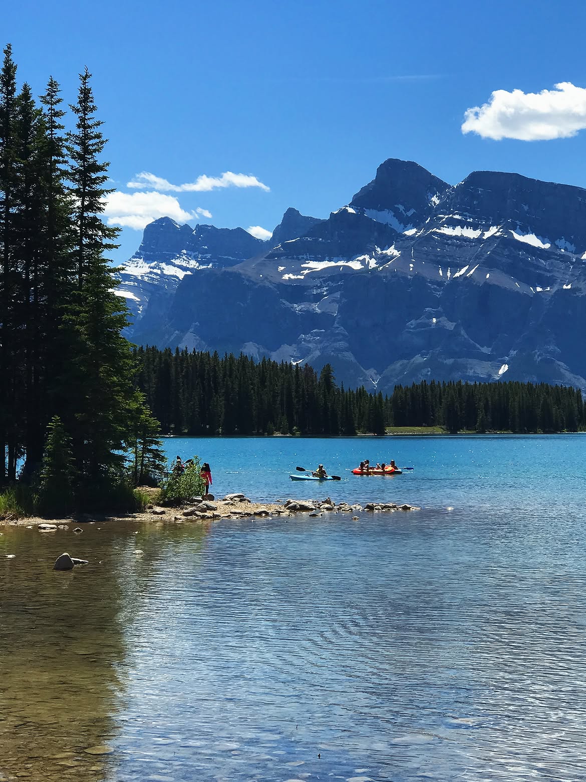 Visitors kayaking and canoeing on Two Jack Lake near the shoreline