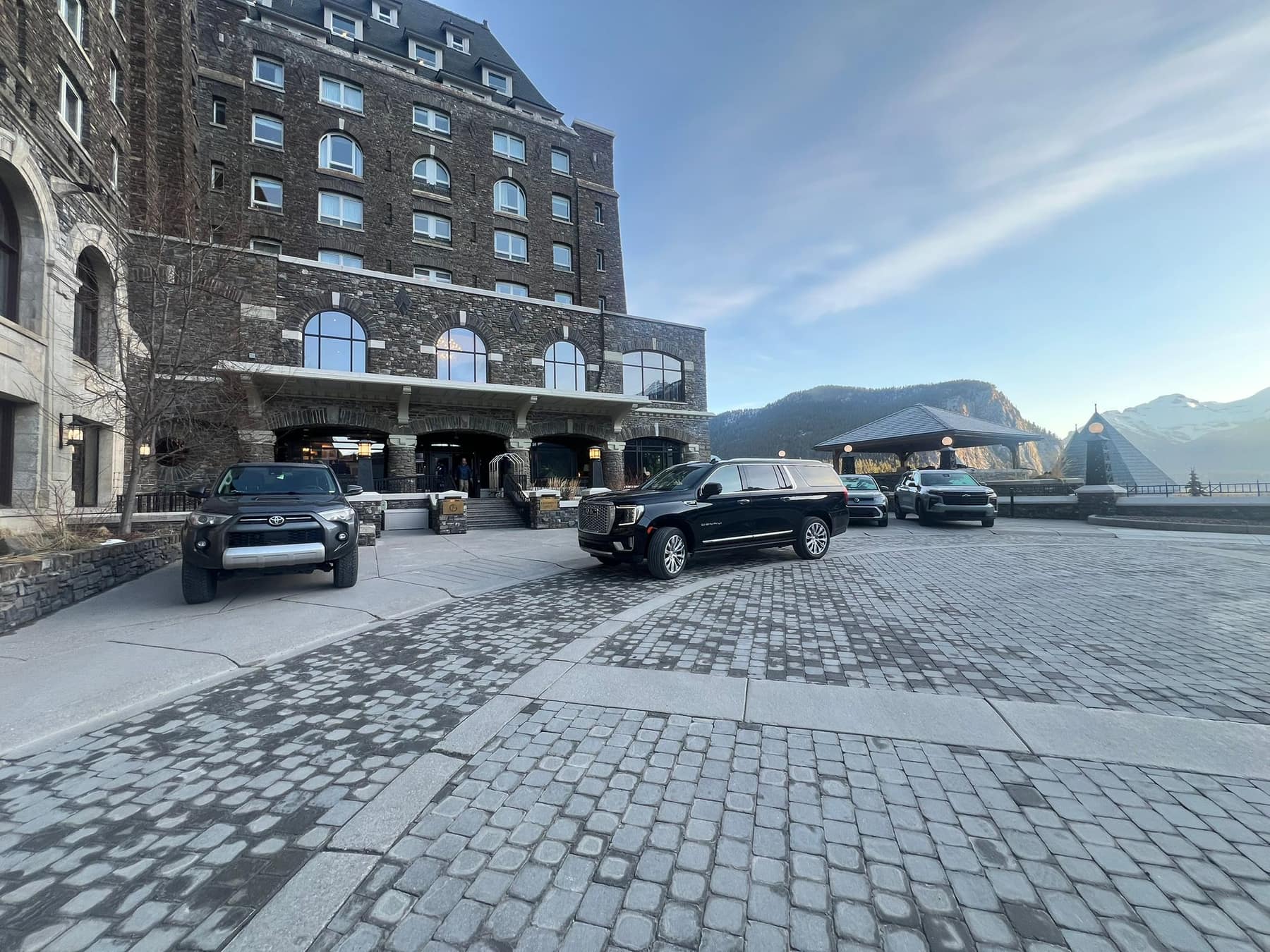 Black GMC Yukon XL Denali waiting at the main entrance of the Fairmont Banff Springs hotel