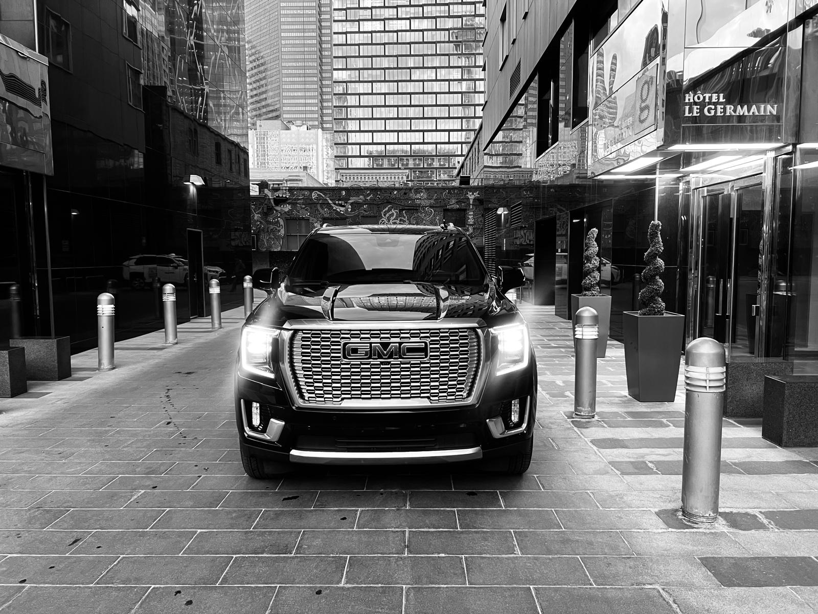Black GMC Yukon Denali waiting at a downtown Calgary hotel entrance for an executive pickup
