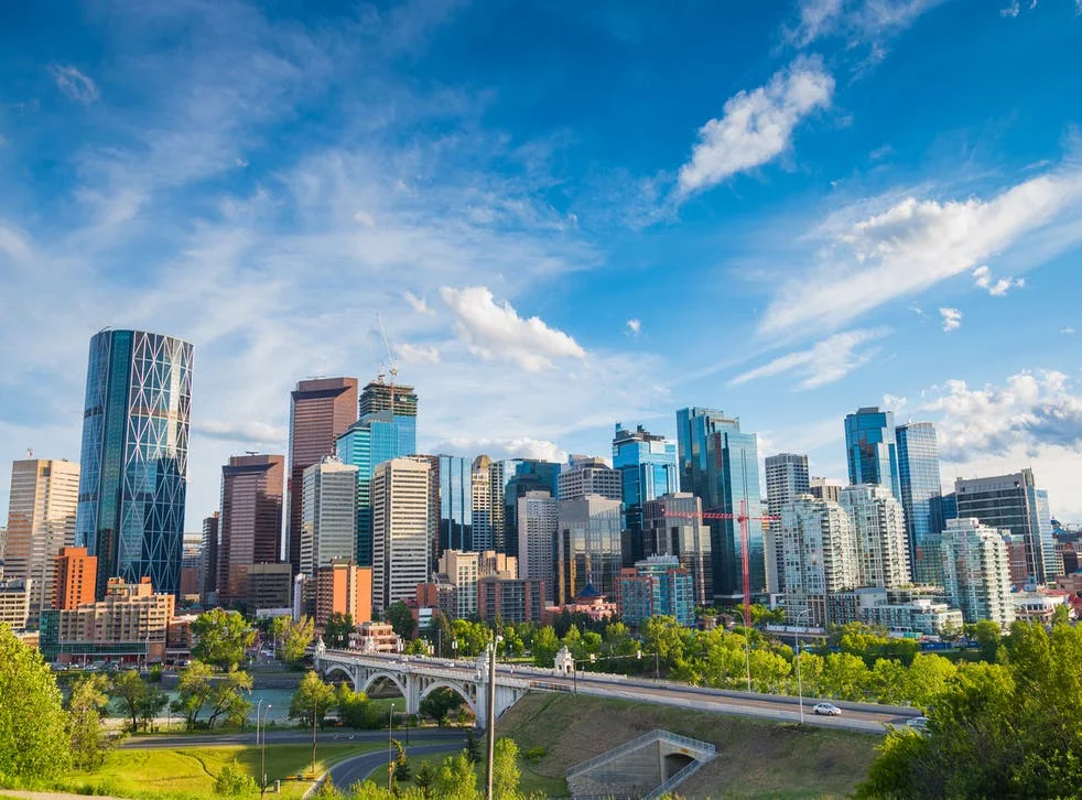 Calgary office towers above the Bow River and Centre Street Bridge on a summer afternoon