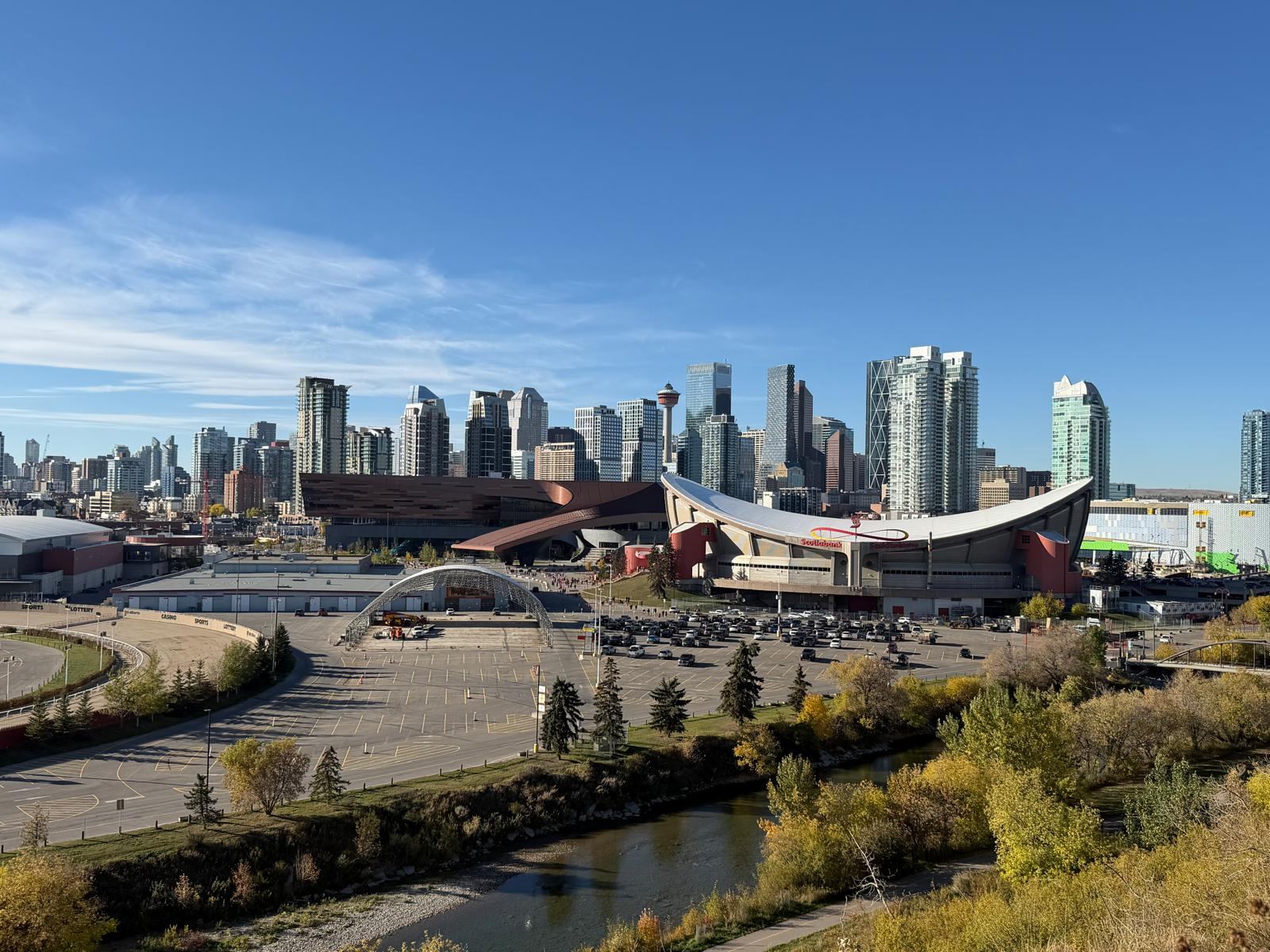 Scotiabank Saddledome and Stampede Park beside the Elbow River, with the Downtown Calgary towers and Calgary Tower behind