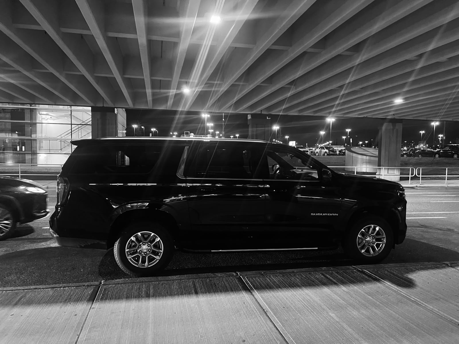 Black Chevrolet Suburban Business SUV ready for a Northwest Calgary pickup at night