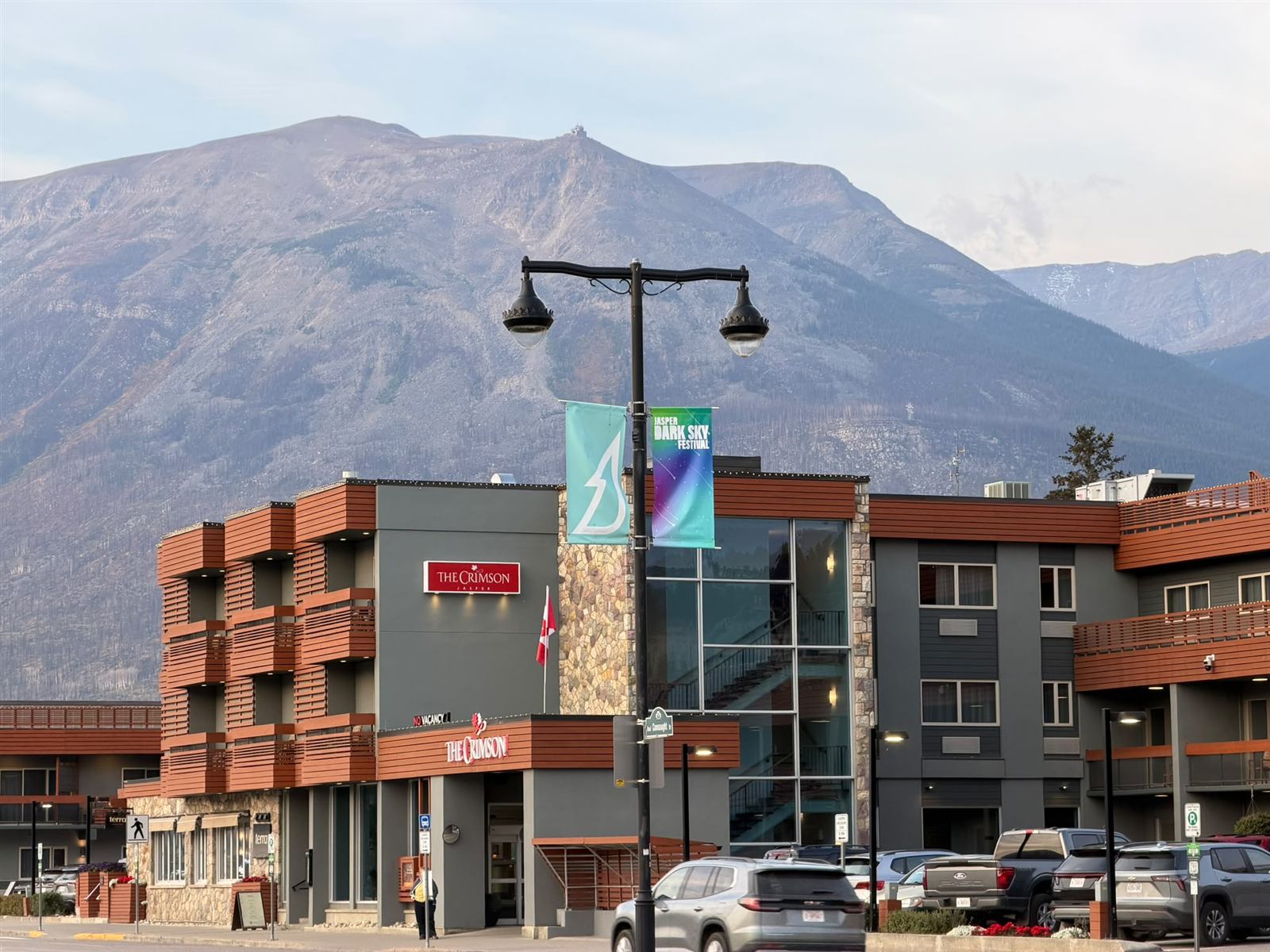 Hotel and shops in downtown Jasper beneath a large mountain