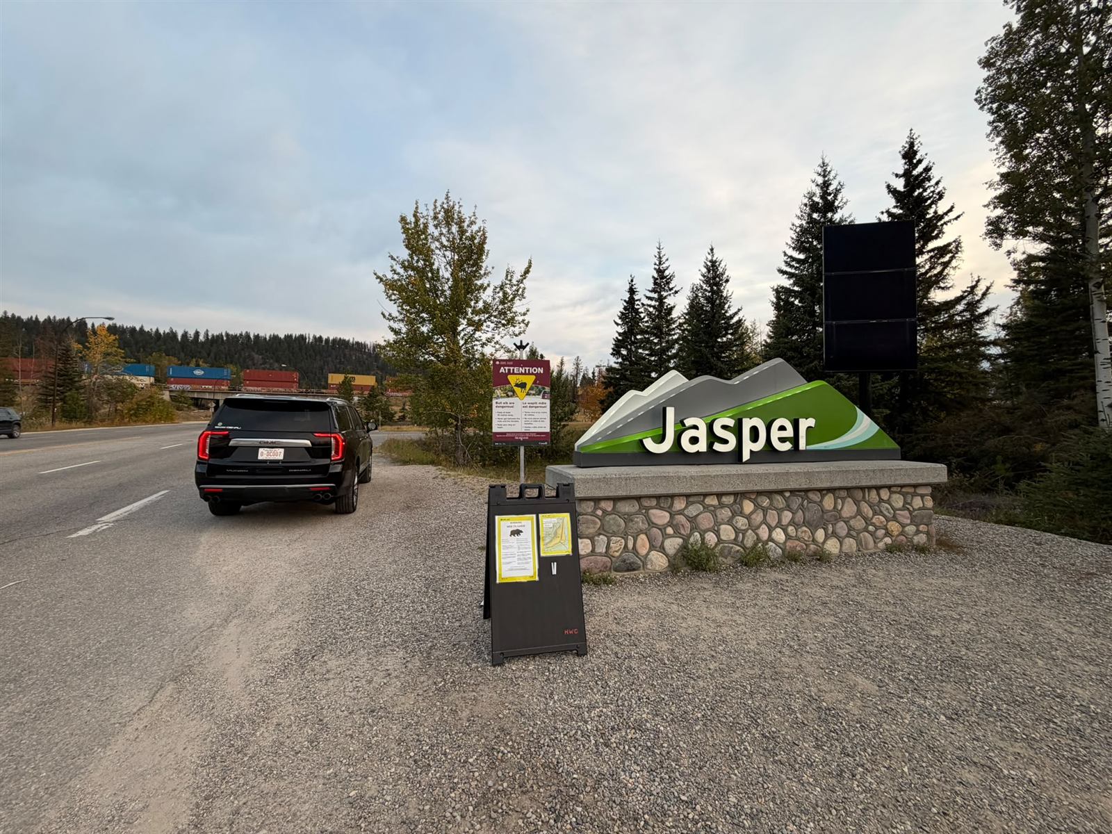 Red Mile Limousine black SUV beside the Jasper welcome sign at the entrance to town
