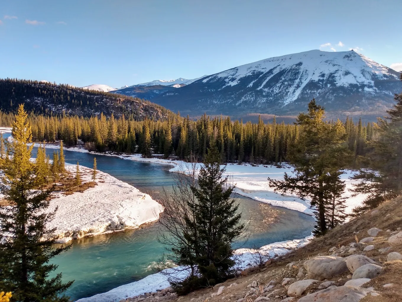 Frozen river channels and a snow-covered valley on the winter route into Jasper
