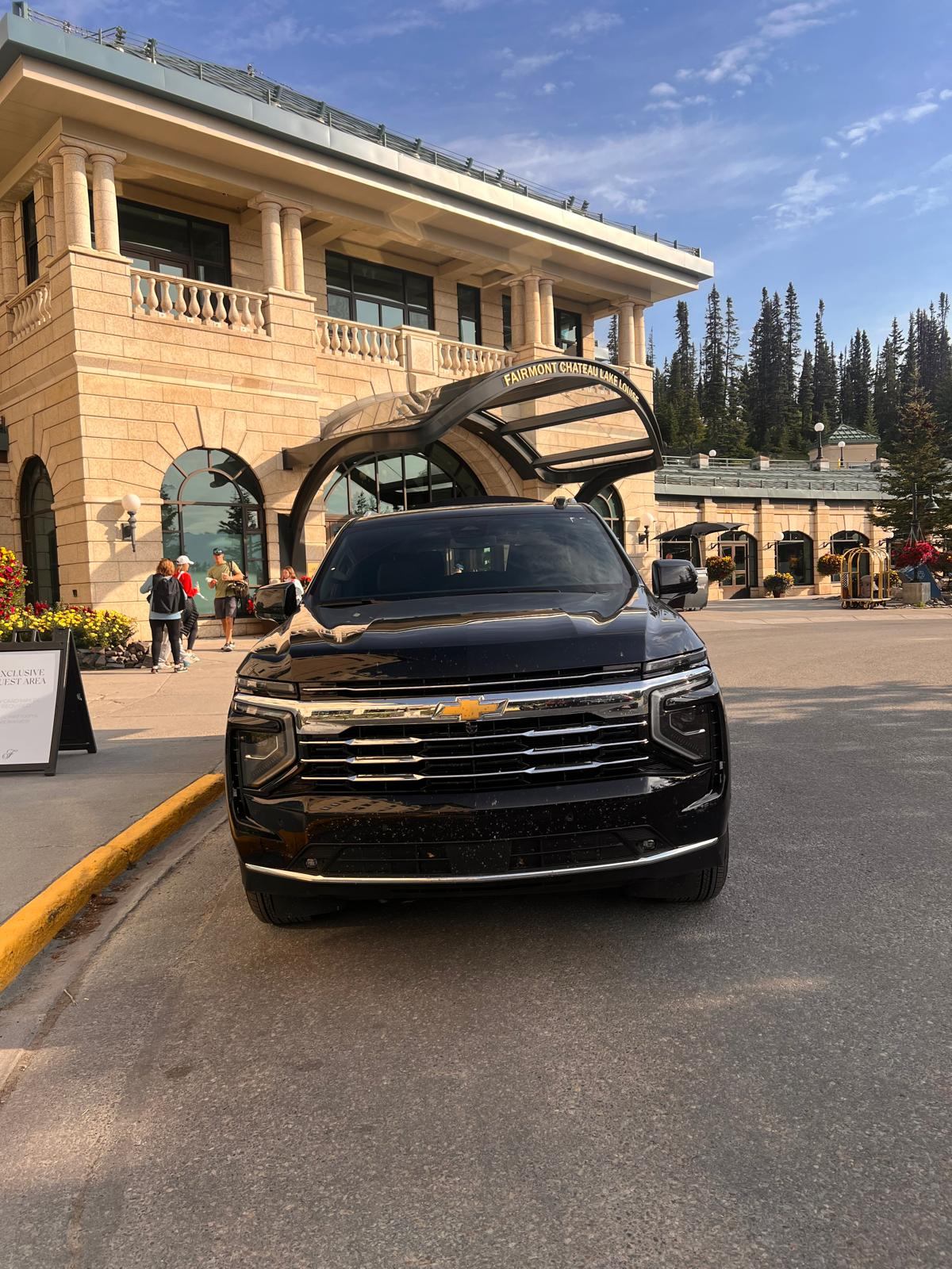 Front view of a Red Mile Limousine Services Chevrolet Suburban outside Fairmont Chateau Lake Louise