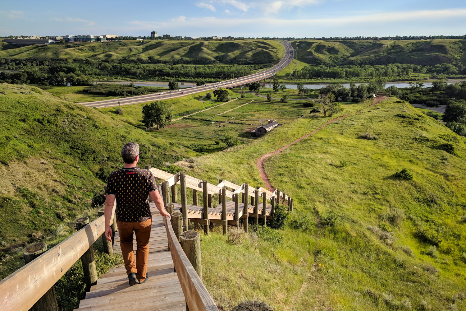 Wooden staircase down the green coulees of the Oldman River valley in Lethbridge